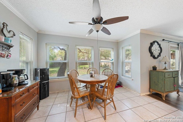 16002 Hickory Well Dr, San Antonio, TX 78247 - dining room featuring a ceiling fan, plenty of natural light, a textured ceiling, light tile patterned flooring, and ornamental molding