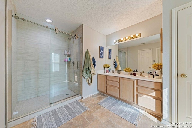 16002 Hickory Well Dr, San Antonio, TX 78247 - bathroom with a shower stall, a textured ceiling, vanity, and baseboards