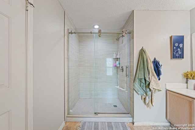 16002 Hickory Well Dr, San Antonio, TX 78247 - bathroom with a stall shower, a textured ceiling, and vanity