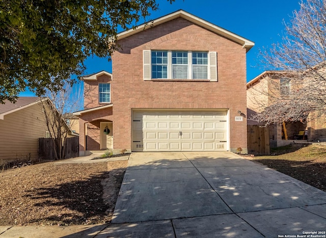 traditional home with an attached garage, fence, driveway, and brick siding