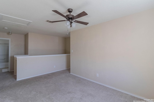 unfurnished room featuring visible vents, light carpet, baseboards, attic access, and a ceiling fan