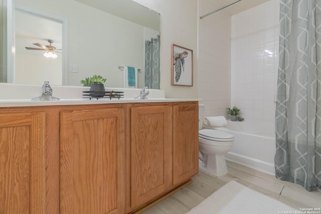 full bathroom with double vanity, a ceiling fan, shower / bath combination with curtain, wood finished floors, and toilet