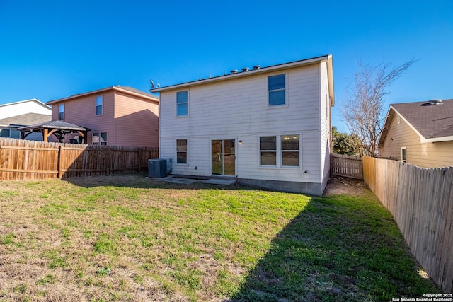 back of house with a gazebo, central AC unit, a lawn, and a fenced backyard