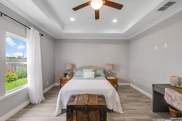 7186 Lake Placid, Corpus Christi, TX 78414 - bedroom featuring visible vents, crown molding, baseboards, light wood-style floors, and a raised ceiling