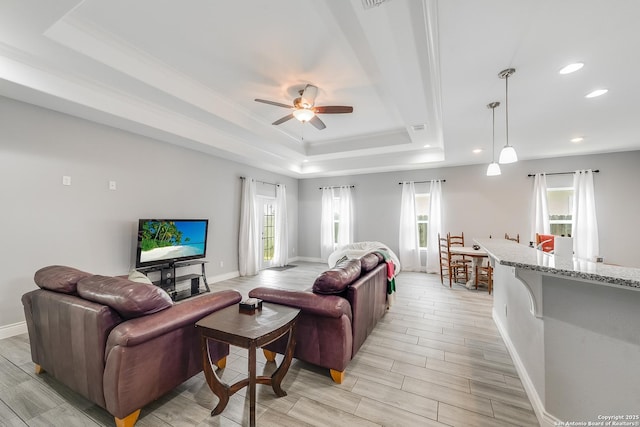 7186 Lake Placid, Corpus Christi, TX 78414 - living area with baseboards, ceiling fan, a tray ceiling, and light wood finished floors
