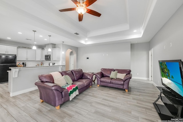 7186 Lake Placid, Corpus Christi, TX 78414 - living area featuring arched walkways, a tray ceiling, recessed lighting, and a ceiling fan