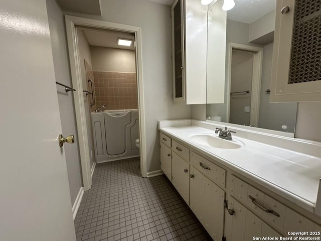 3624 Richwood, San Antonio, TX 78230 - full bathroom featuring vanity, toilet, baseboards, a bathtub, and tile patterned floors