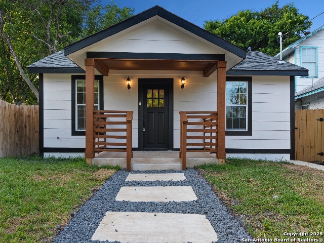 1851 Dawson St, San Antonio, TX 78202 - bungalow-style house featuring a front lawn, roof with shingles, and fence