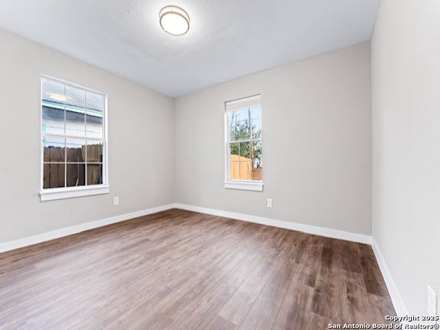 1851 Dawson St, San Antonio, TX 78202 - unfurnished room with baseboards and wood finished floors