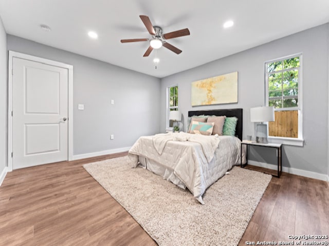 1851 Dawson St, San Antonio, TX 78202 - bedroom featuring multiple windows, baseboards, wood finished floors, recessed lighting, and ceiling fan