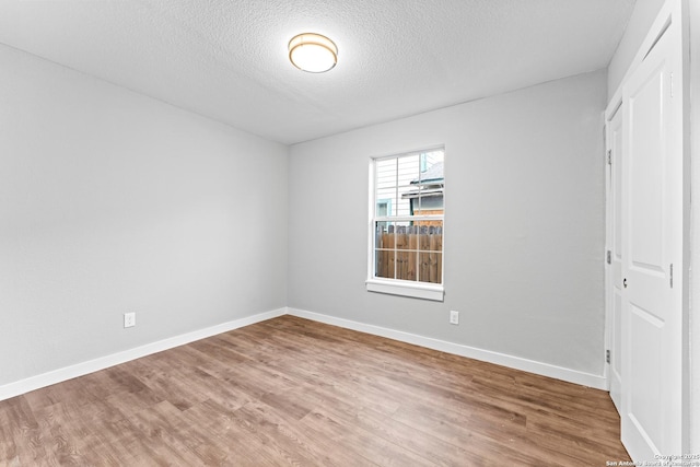 1851 Dawson St, San Antonio, TX 78202 - unfurnished bedroom featuring wood finished floors, a textured ceiling, and baseboards