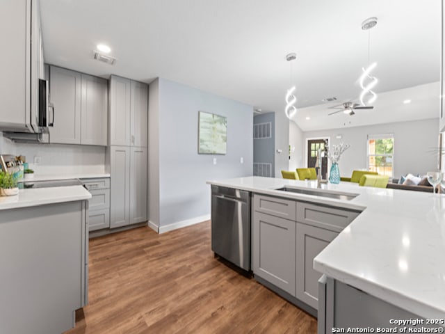 1851 Dawson St, San Antonio, TX 78202 - kitchen featuring light countertops, gray cabinets, a ceiling fan, and stainless steel appliances
