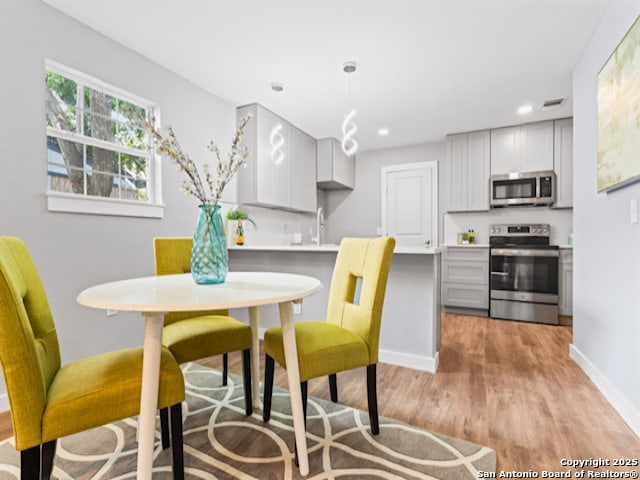 1851 Dawson St, San Antonio, TX 78202 - dining space featuring baseboards, light wood-style floors, and recessed lighting