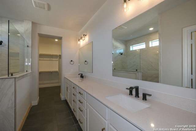 2707 Wild Skies, San Antonio, TX 78245 - bathroom with a walk in shower, a sink, double vanity, tile patterned floors, and visible vents