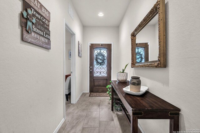 9154 Curling Post, Schertz, TX 78154 - doorway featuring baseboards, a textured wall, and visible vents