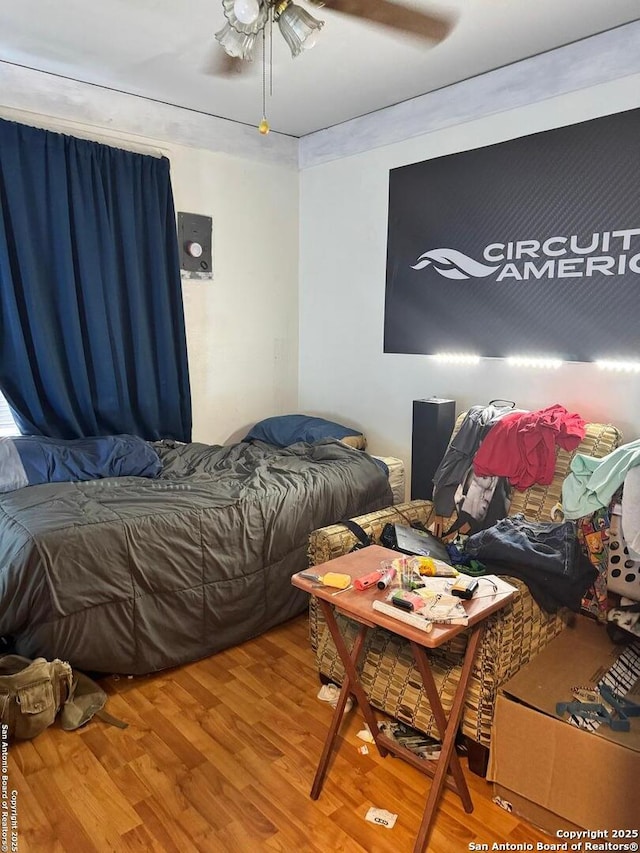 bedroom featuring ceiling fan and wood finished floors