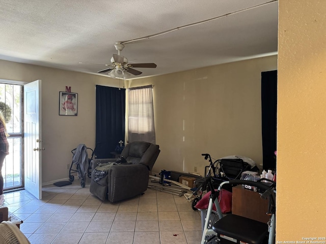 living room with a ceiling fan and light tile patterned flooring