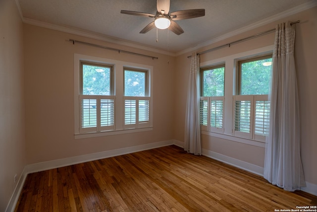 unfurnished room featuring baseboards, light wood finished floors, and crown molding