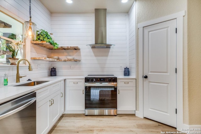 kitchen with electric range, open shelves, a sink, wall chimney exhaust hood, and stainless steel dishwasher
