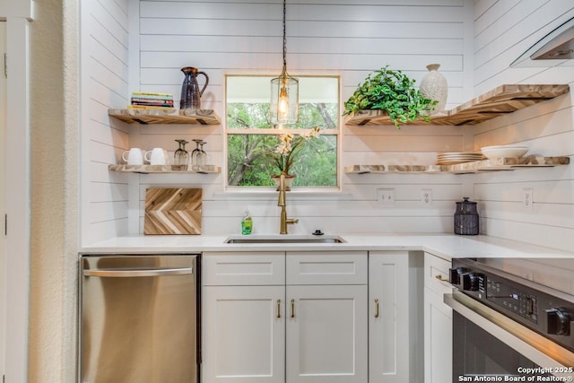 kitchen featuring open shelves, dishwasher, light countertops, white cabinets, and range