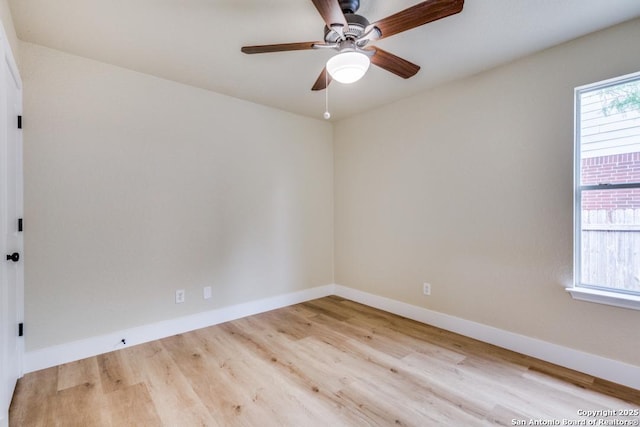 spare room with baseboards, a ceiling fan, and wood finished floors