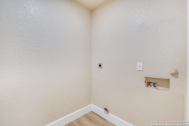 laundry room with laundry area, hookup for a washing machine, baseboards, electric dryer hookup, and light wood-type flooring
