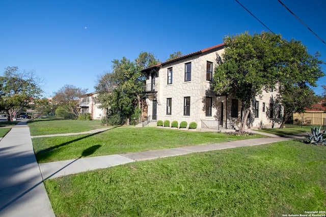 view of front of property with a front yard and stone siding