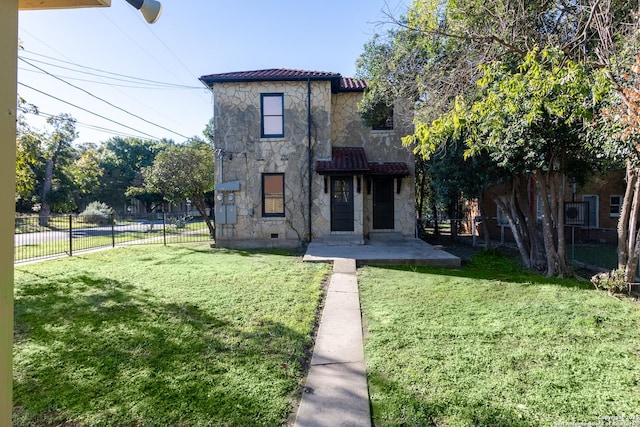 view of front facade featuring a front yard, fence, and stone siding