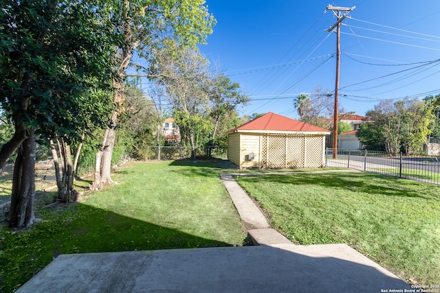view of yard featuring an outdoor structure and fence
