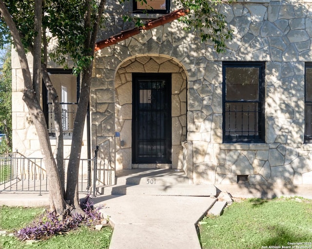 view of exterior entry featuring stone siding