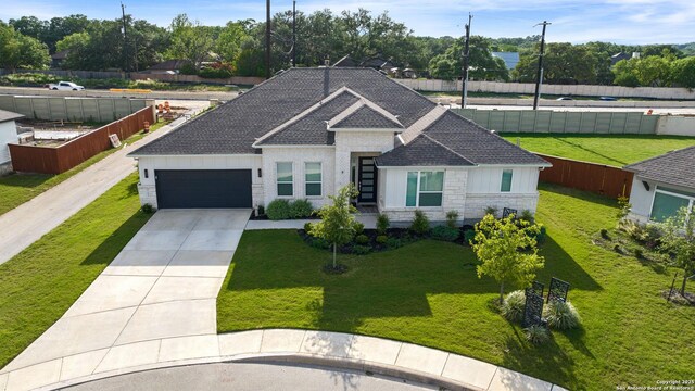 29919 Capstone Walk, Boerne, TX 78015 - view of front facade with an attached garage, roof with shingles, driveway, and a front yard