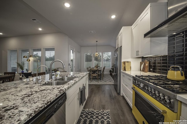 29919 Capstone Walk, Boerne, TX 78015 - kitchen with visible vents, wall chimney exhaust hood, a sink, dark wood finished floors, and appliances with stainless steel finishes