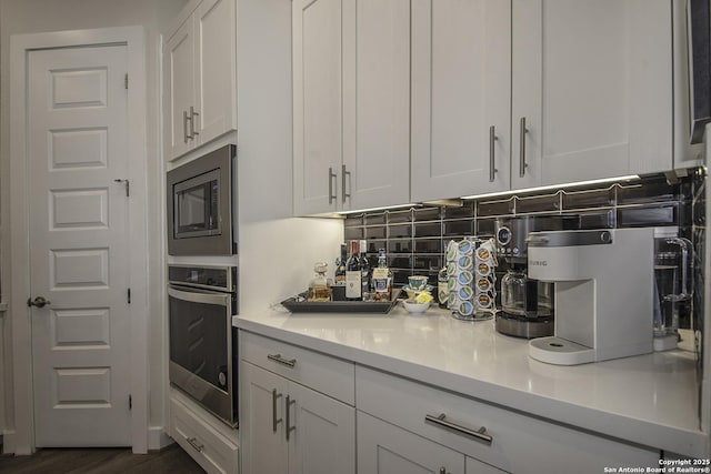 29919 Capstone Walk, Boerne, TX 78015 - kitchen with dark wood-style flooring, light countertops, white cabinets, tasteful backsplash, and stainless steel appliances