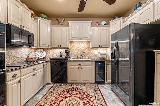 kitchen with dark countertops, a sink, beverage cooler, a ceiling fan, and black appliances