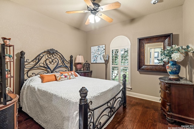 bedroom featuring a ceiling fan, baseboards, and wood finished floors