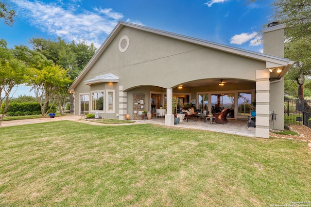 rear view of property featuring a yard, fence, outdoor lounge area, and a chimney