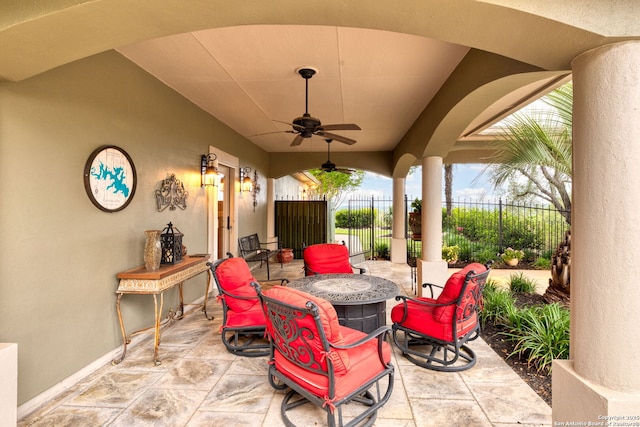 view of patio with fence and a ceiling fan