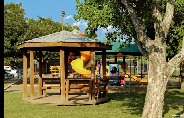 community playground featuring fence, a gazebo, and a yard