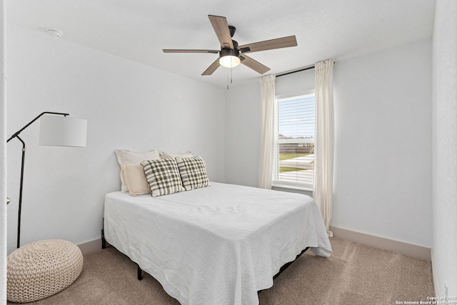 bedroom featuring baseboards, a ceiling fan, and carpet flooring
