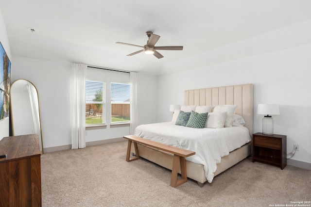 bedroom with a ceiling fan, baseboards, and light colored carpet