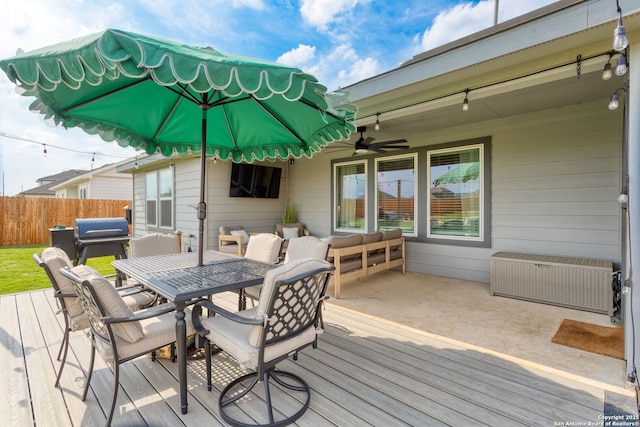 deck featuring fence, a ceiling fan, and outdoor dining area