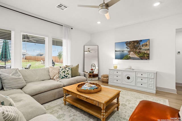 living room with visible vents, baseboards, recessed lighting, a ceiling fan, and light wood finished floors