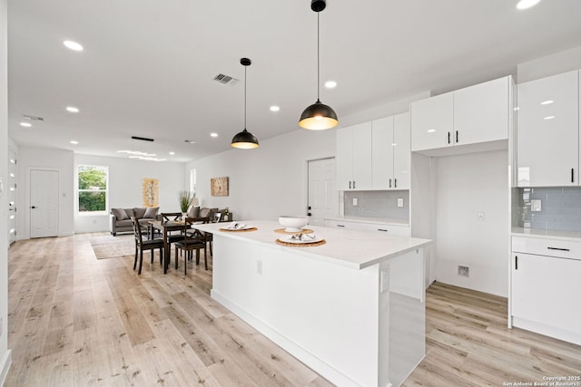 kitchen featuring visible vents, recessed lighting, light wood-type flooring, white cabinetry, and tasteful backsplash