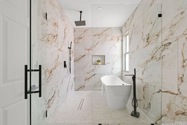 full bathroom with a freestanding tub, tile walls, and a marble finish shower