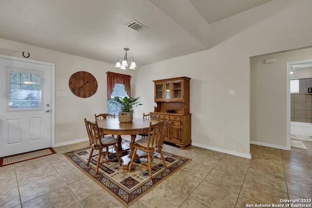 dining space with visible vents, baseboards, a healthy amount of sunlight, and a notable chandelier