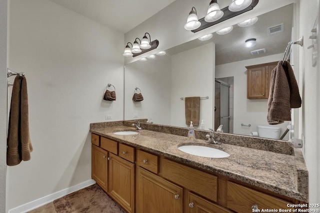 full bathroom with a sink, an enclosed shower, and visible vents