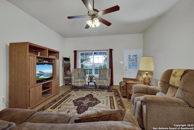 living area with baseboards and ceiling fan