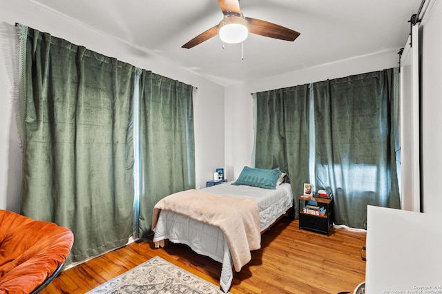 bedroom with ceiling fan and wood finished floors