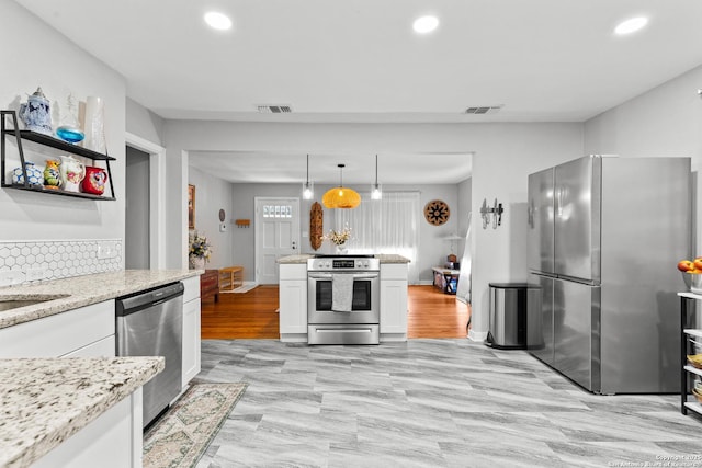kitchen with white cabinetry, recessed lighting, stainless steel appliances, and visible vents