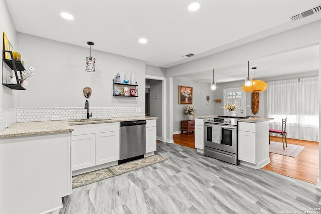 kitchen featuring a sink, white cabinets, visible vents, and appliances with stainless steel finishes